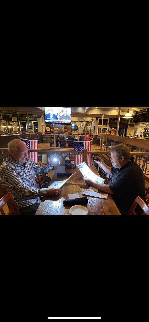 My dad and his best friend trying to find the drink menu