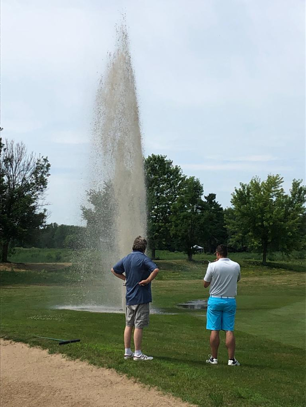 My Dad hit a sprinkler dead on with one of his drives today at a local golf tournament Hes in the blue shirt