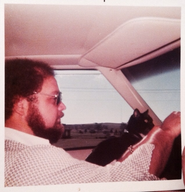 My Dad passed away recently Going through family albums and I come across this  Dad use to drive around with his cat Boots Thought Reddit would like it