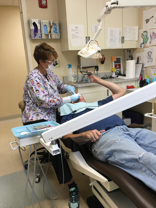 My dad snapping a selfie while my mom cleans his teeth