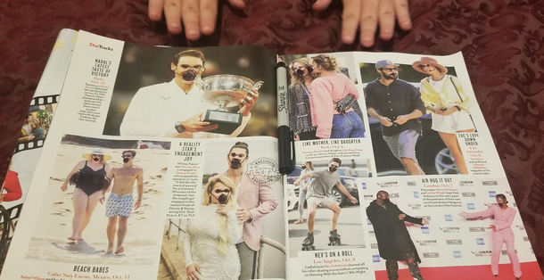 My daughter drew masks on the people in the magazine