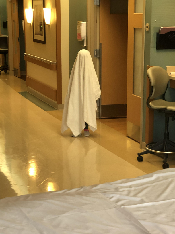 My daughter pretending to be a ghost at the hospital Probably a poor choice