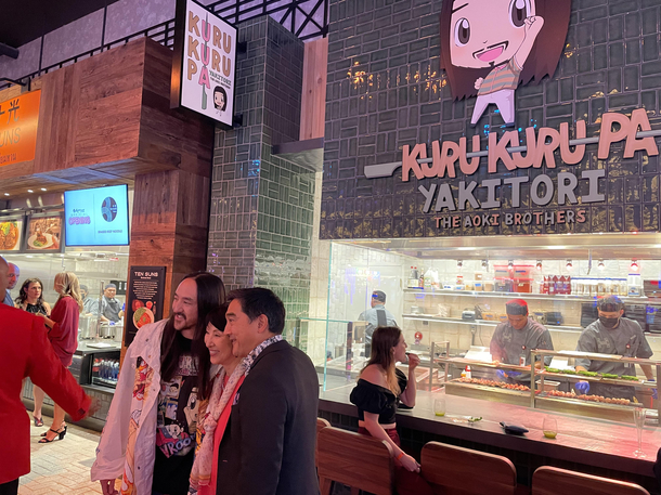 My friend invited me to a hotel opening where Steve Aoki opened a restaurant Here I am cluelessly eating shishito peppers in the background of pics with his parents