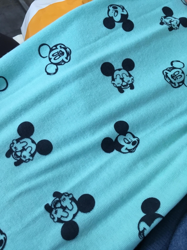 My girlfriend bought this Mickey Mouse scarf for our baby She didnt look close enough at what gesture hes making