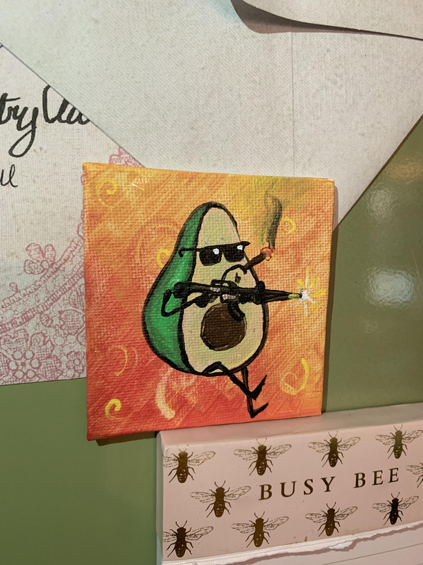 My husband painted a smoking avocado with a machine gun He calls it Commandocado