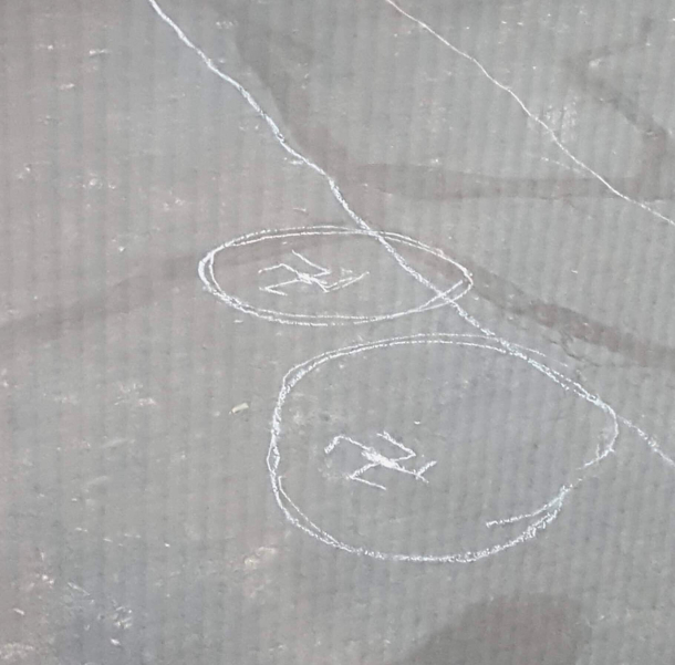 My kid is not a Nazi My  year old son wanted to know how to draw the face off circles for hockey in our driveway I said its easy you just draw a dot in the middle then  Ls around it This is what I found I later