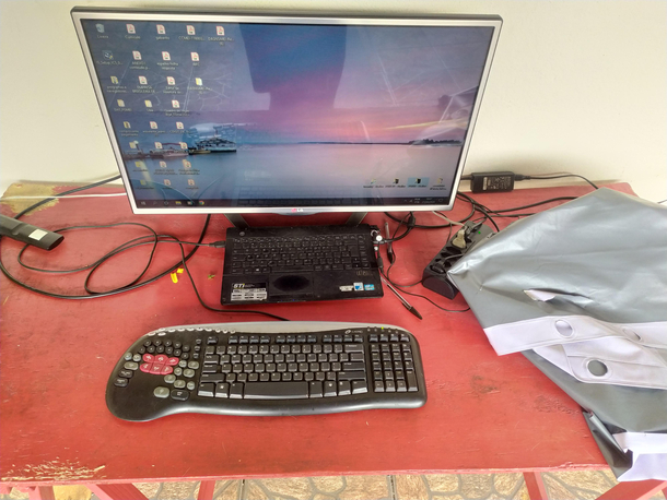 My moms apocalypse setup Notebook with a screen ripped off and a broken keyboard connected to a old TV and garbage gaming keyboard