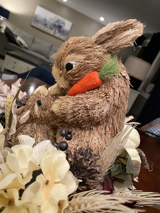 My mother-in-laws Easter table decoration is a big rabbit murdering a little rabbit for a carrot