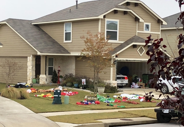 My neighbors yard looks like the location where the battle for Christmas was foughtand lost