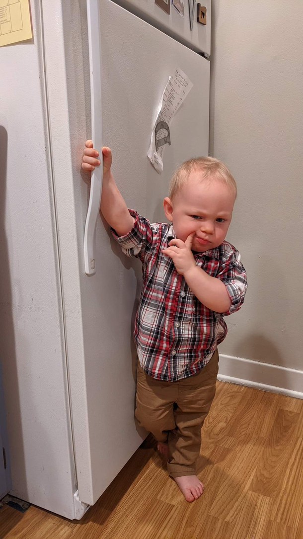 My nephew pondering what to eat in the fridge