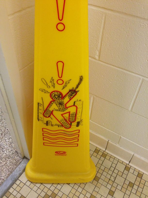 Neat artwork on wet floor cone