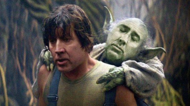 NICOLAS skywalker carries a sleepy yoda CAGE