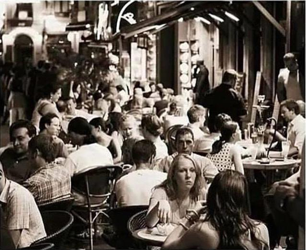 Old photo of people eating at a crowded restaurant  BC Before Corona 