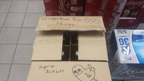 Opening a repacked box of wine at the liquor store when