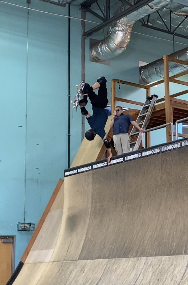 Patton Oswalt snapping a photo while Tony Hawk shows off his moves