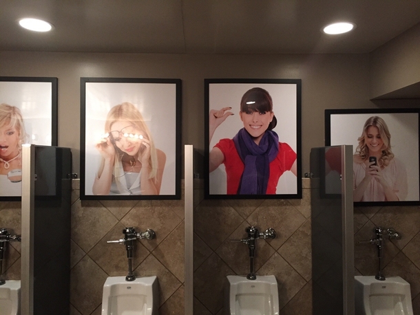 Pictures above the urinals at a bar