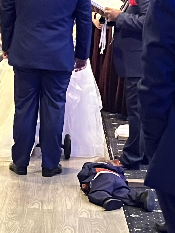 Poor little guy was bored to death at his parents wedding
