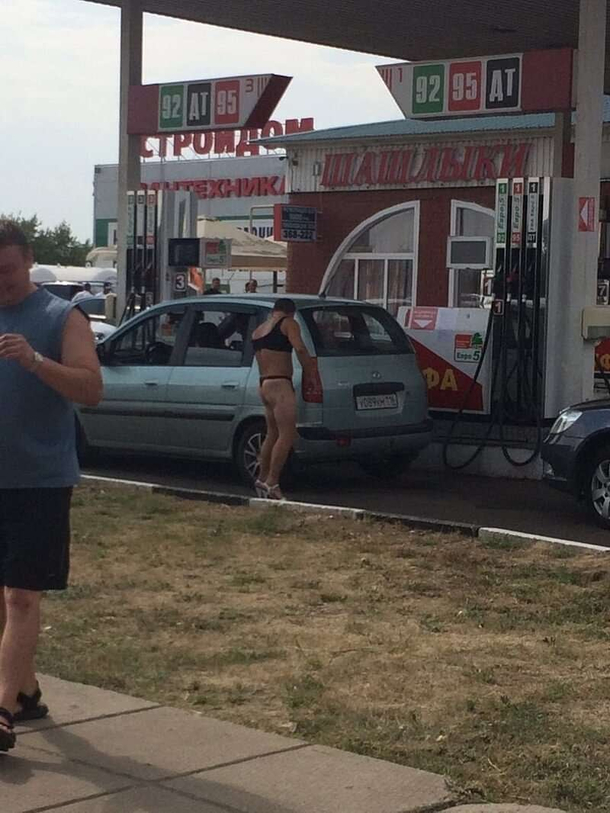 Russian gas station offers free fuel to those in bikini men reach in two-pieces