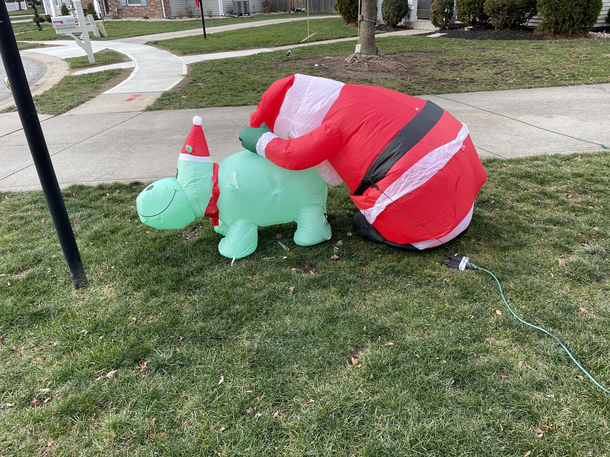 Santa is either tired and glad Christmas is over or just got done with the hippo cant figure out which one