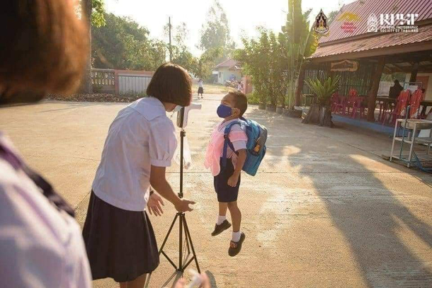 Scanning temperatures before school Determined kid