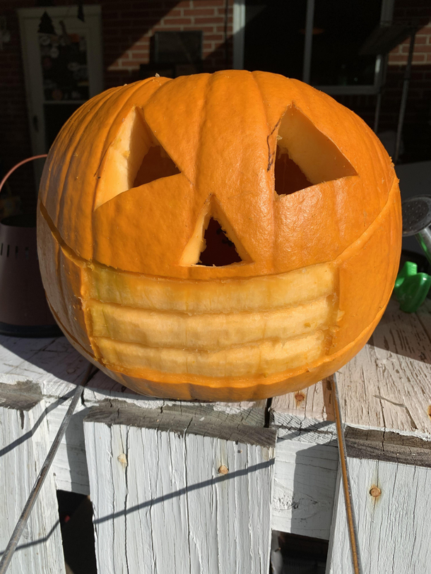 Scary pumpkin wearing his mask under his nose