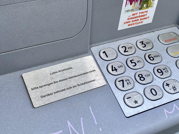 Sign says Dear criminals please dont blow up this ATM Theres a bedroom above