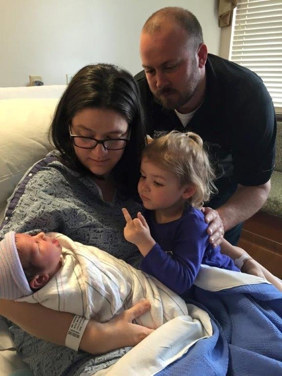 Sister welcomes newborn sibling to the family