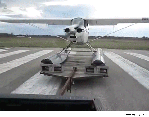 Small aircraft using a truck to takeoff