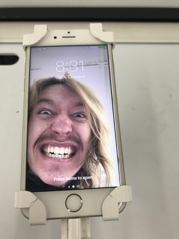 So I was at Walmart and they had display iPhones Somebody took a picture of themselves and I set it as the background Its just some random dude lol