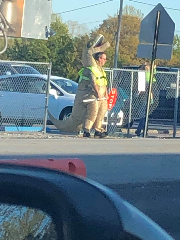 So my wife sends me a picture just nowthis is the principal at my kids schooldressed as a trexwhile being a crossing guardI cant imagine the bet he lost over the weekend for this to happen Easily the coolest principal ever though
