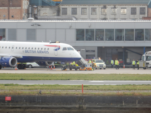Some guy at the London City Airport has glued himself to a plane for some reason