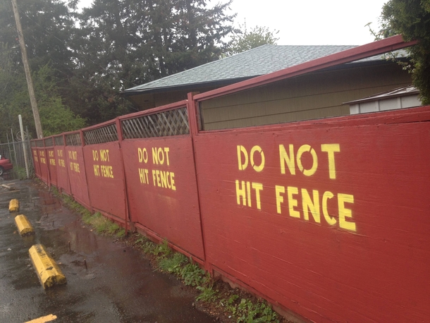 Some one from the auto place next door hit our fence twice so our landlord painted this passive aggressive note on their side