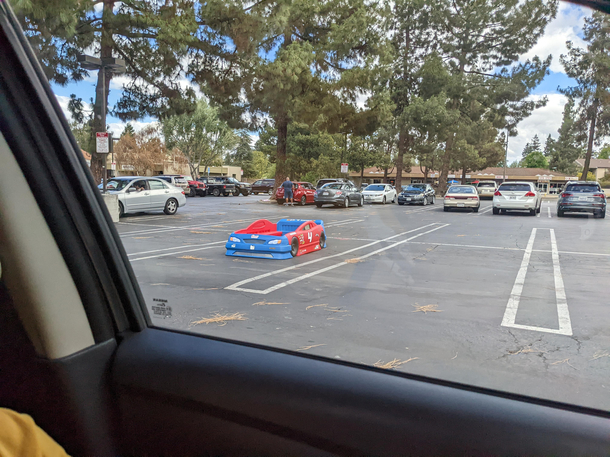 Someone parked their car bed in an actual parking spot