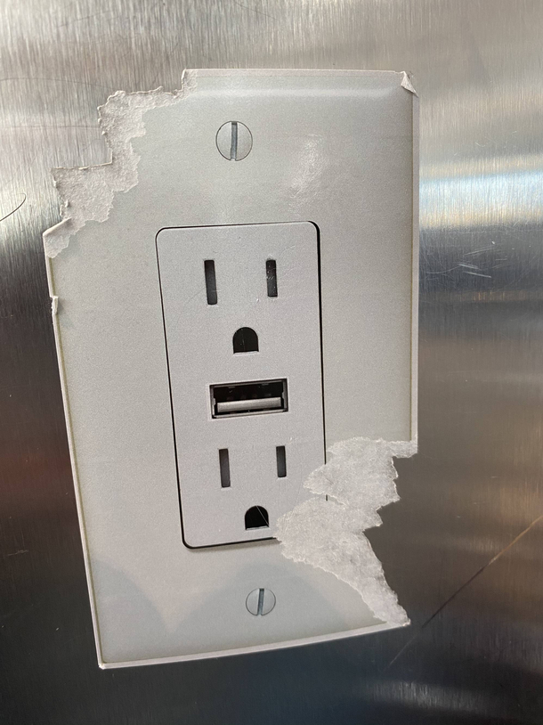 Someone put a sticker of a outletUSB charger on one of the posts at the Denver International Airport Someone didnt find it funny