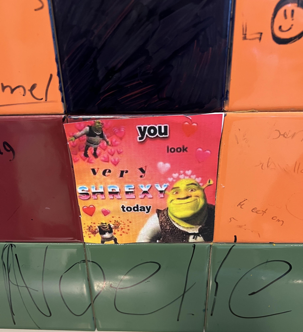 Someone put this on a mosaic tile wall in my school
