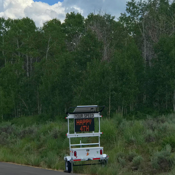 Speed limit sign up the canyon wishes you Happy Fourth of July rather than yelling at you