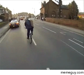 Taking off his jacket while riding a bike
