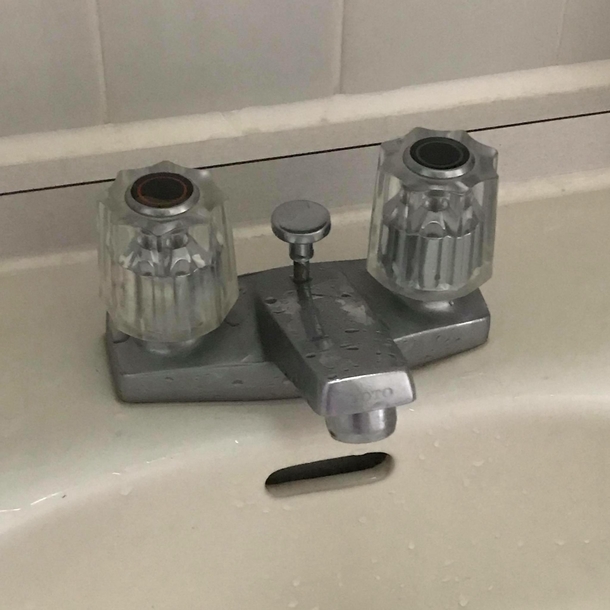 The faucet inside my work bathroom always looks utterly unamused