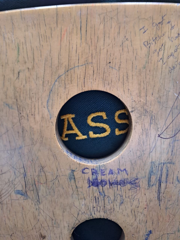the hole in the back of the chair crops out the shirt of the guy sitting in front of me perfectly