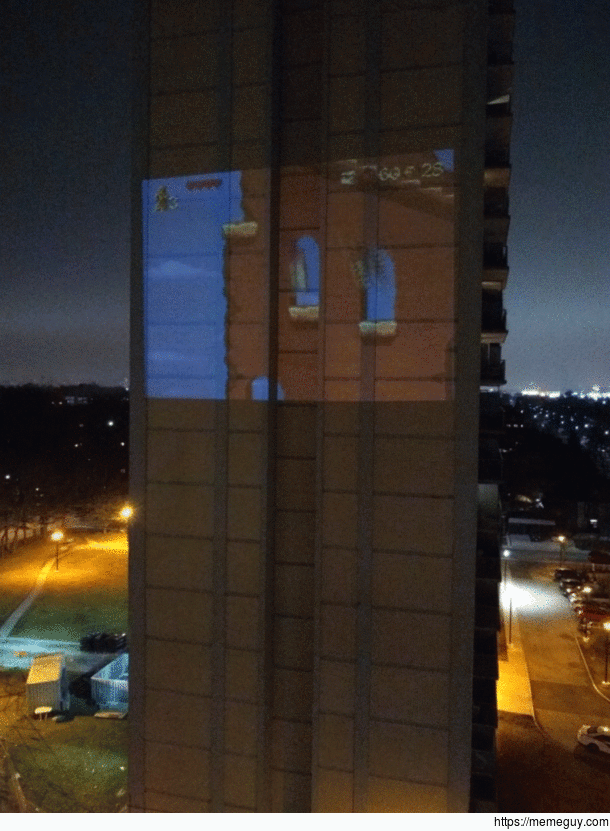 The neighbors playing video games with a projector using the condo next to them as a back drop haha