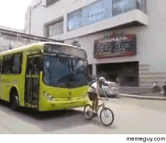 This biker decides to go nice and slow in front of a bus