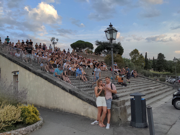 This dude came to a location where people sit and watch the sunset then started singing in front of them For anyone passing by it seemed like everyone was here for the singing