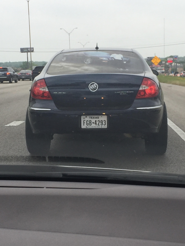 This dude has a picture of himself with his car across the entire back window of his car