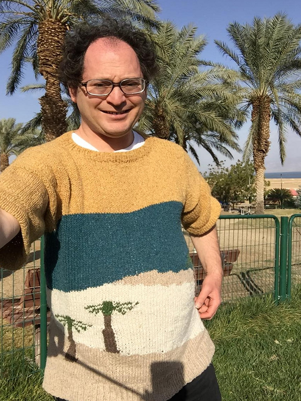 This guy makes sweaters of places and then takes pictures of himself wearing the sweaters at those places