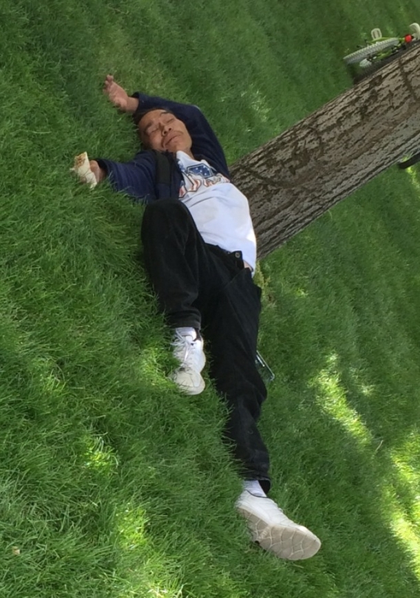 This guy passed out at the park with a burrito in his hand
