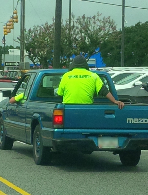 This guys shirt while riding in a truck bed