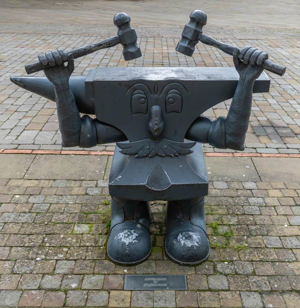 this is a sculpture in my hometown he is called Anvil Man I remember stubbing my toe on him as a child