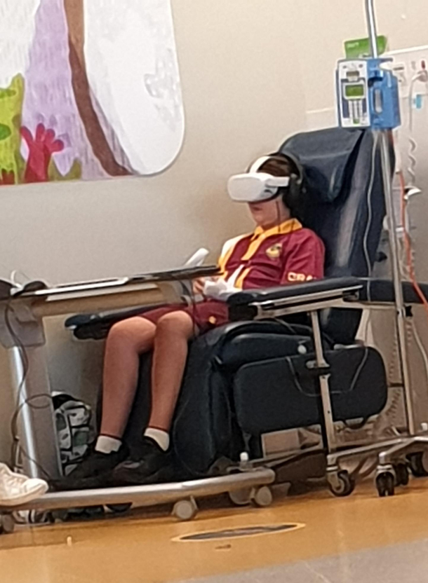This kid is casually playing VR while he gets his medical treatment