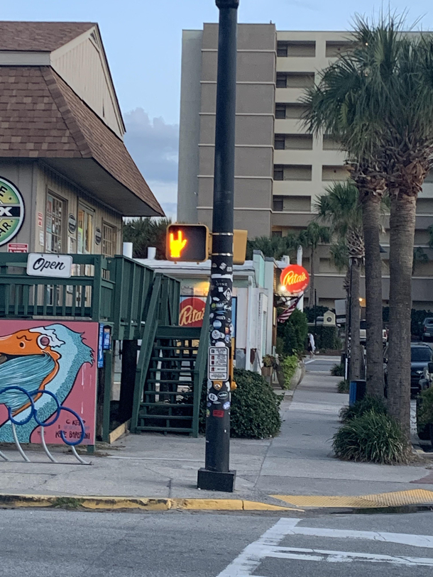 This pedestrian light in Folly Beach I assume its broken because all of the others around it have five fingers