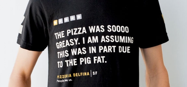 This Pizzeria employee is wearing T-Shirts with quotes from nasty yelp review